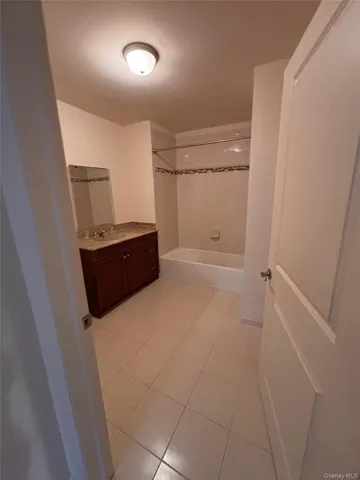 a bathroom with a vanity and tub
