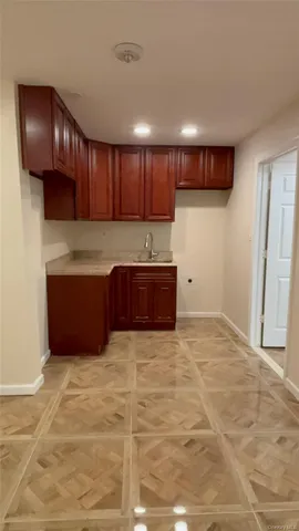 a view of kitchen with stainless steel appliances wooden cabinets and entryway