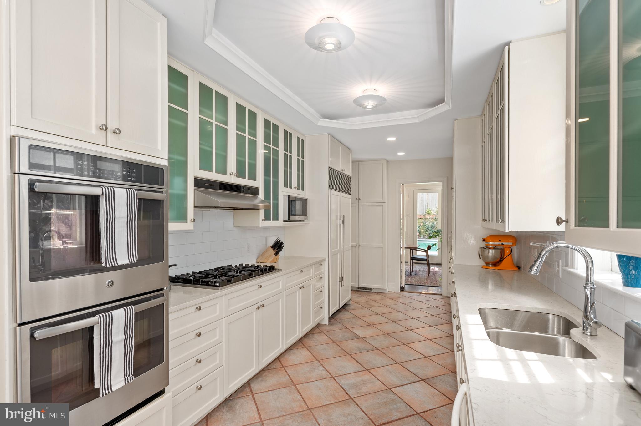 2468 Belmont Road Northwest Washington, DC 20008 - Photo 17 of 49 a kitchen with stainless steel appliances kitchen island granite countertop a sink and cabinets