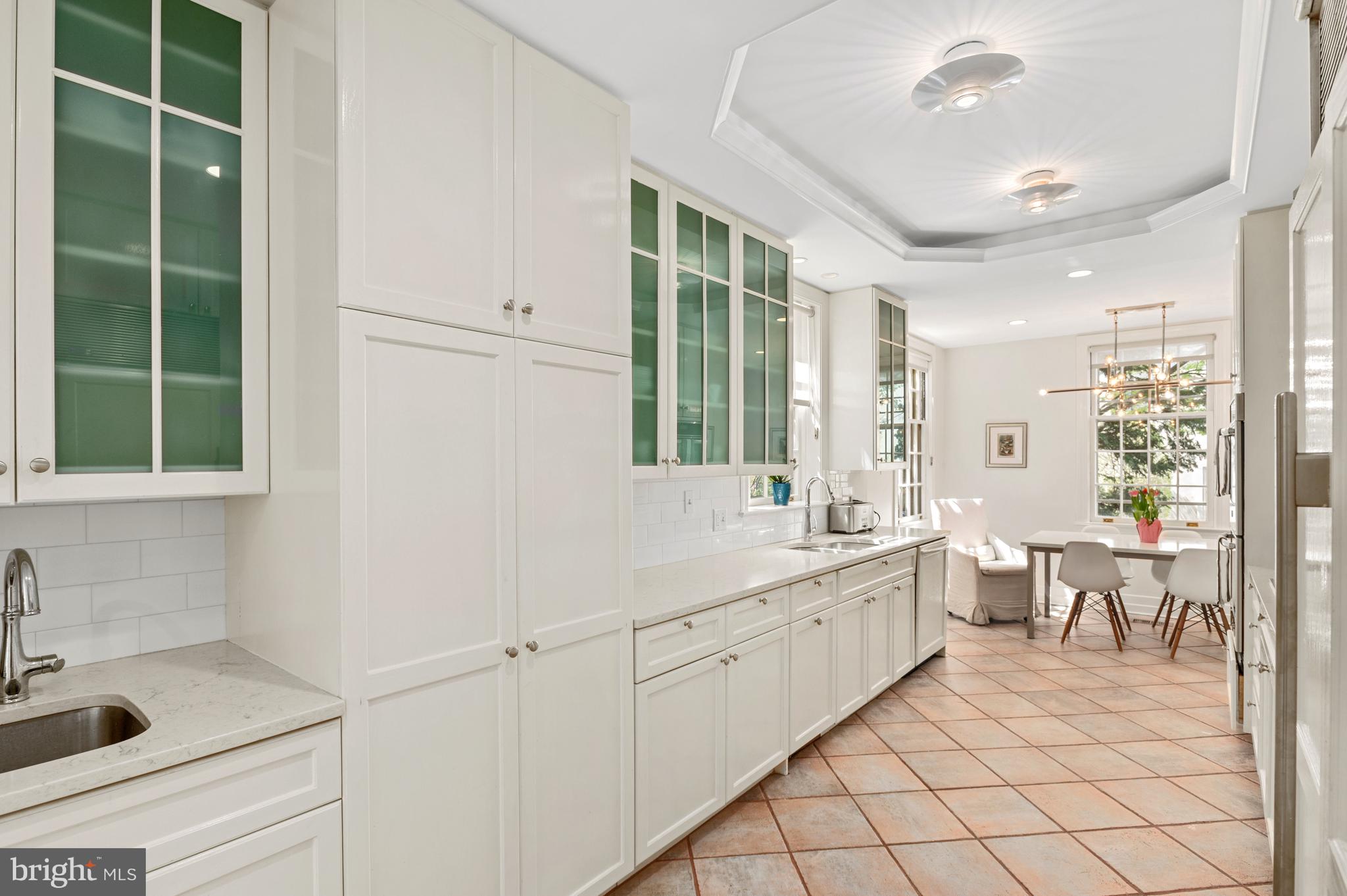 2468 Belmont Road Northwest Washington, DC 20008 - Photo 23 of 49 a large white kitchen with sink and window