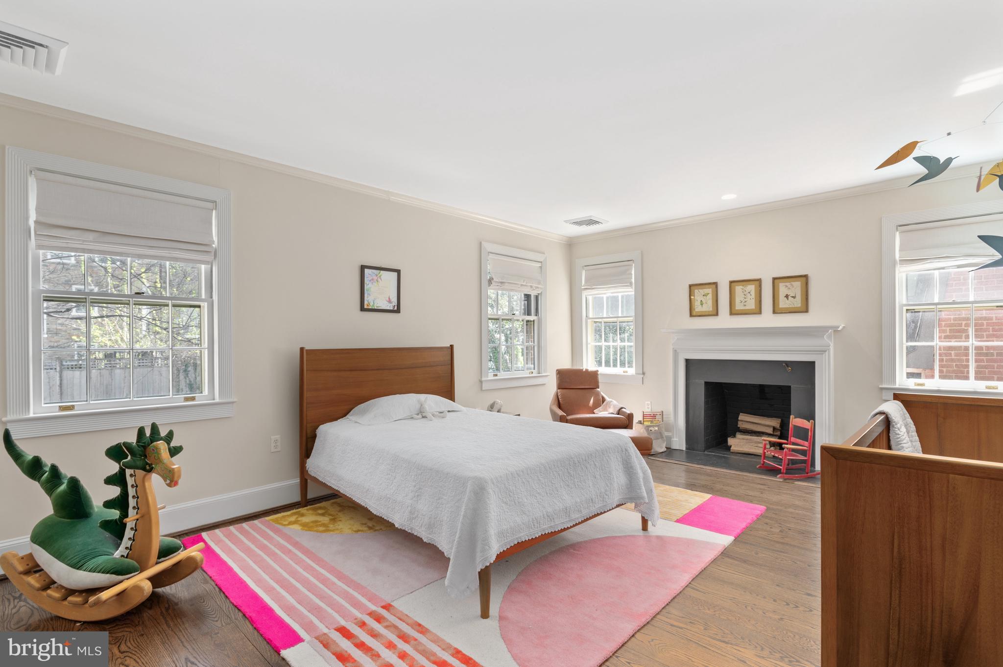 2468 Belmont Road Northwest Washington, DC 20008 - Photo 29 of 49 a bedroom with a bed bathtub and a fireplace