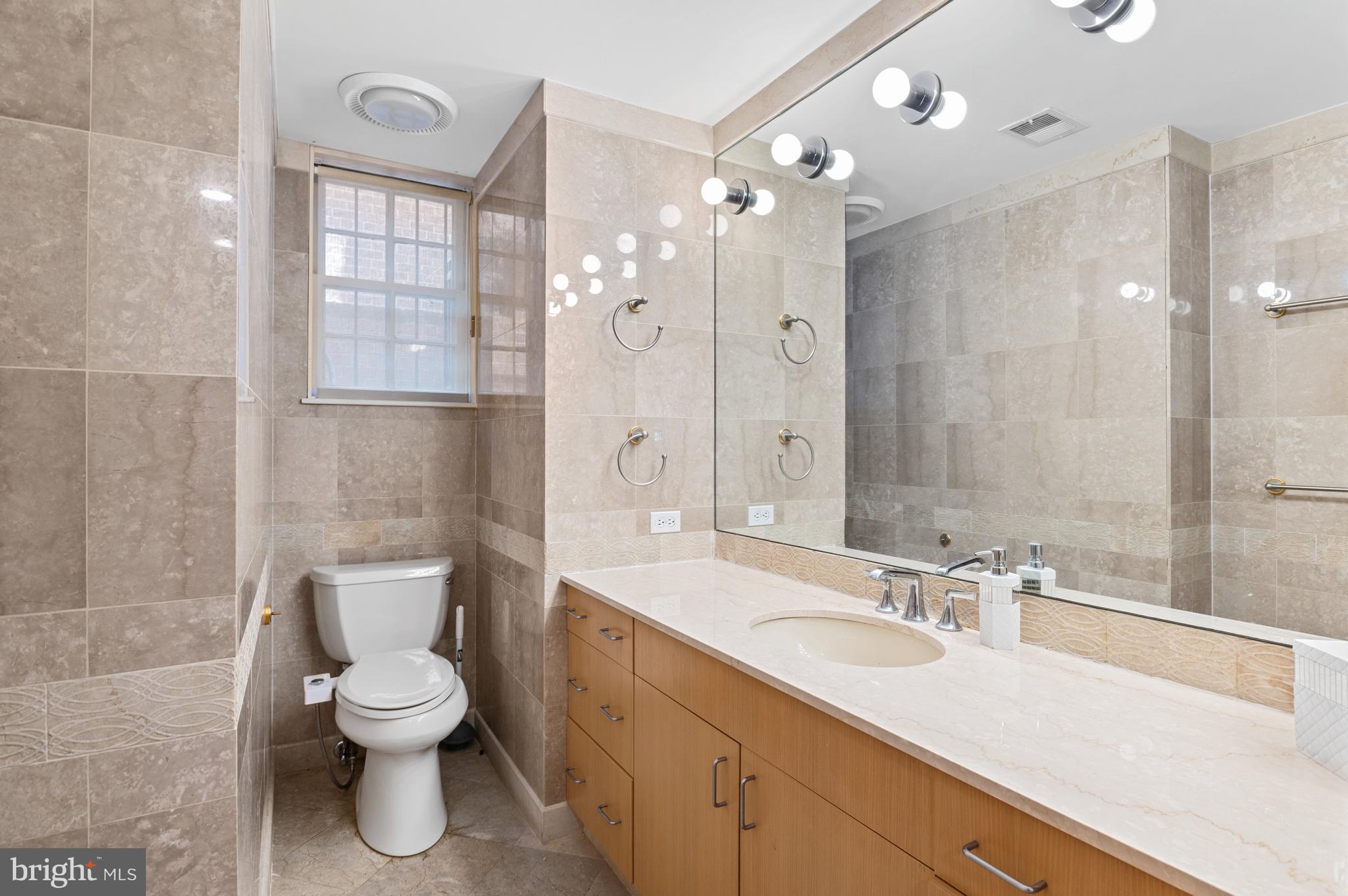 2468 Belmont Road Northwest Washington, DC 20008 - Photo 33 of 49 a bathroom with a sink a toilet and shower