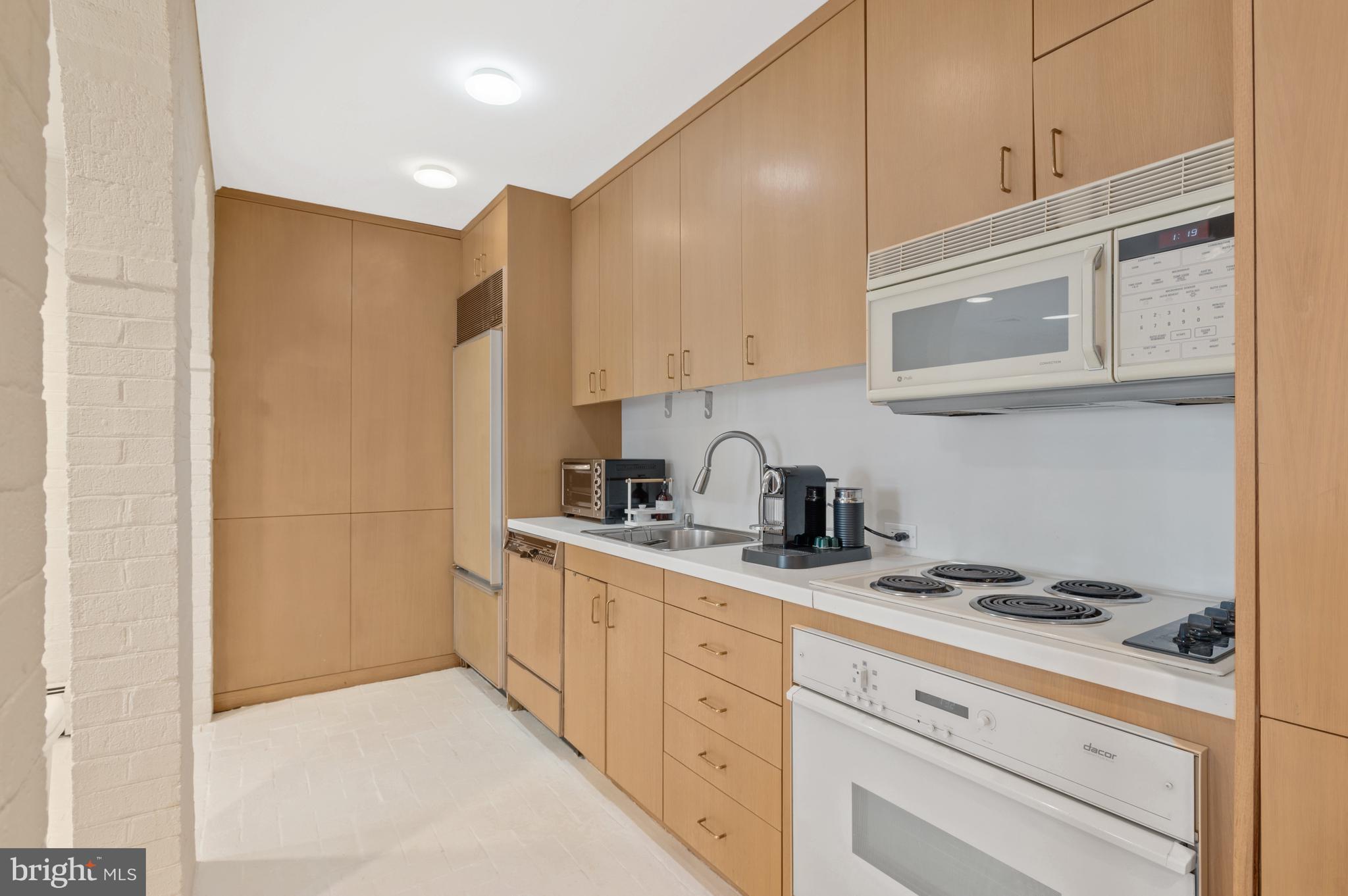 2468 Belmont Road Northwest Washington, DC 20008 - Photo 40 of 49 a kitchen with stainless steel appliances granite countertop a sink and cabinets