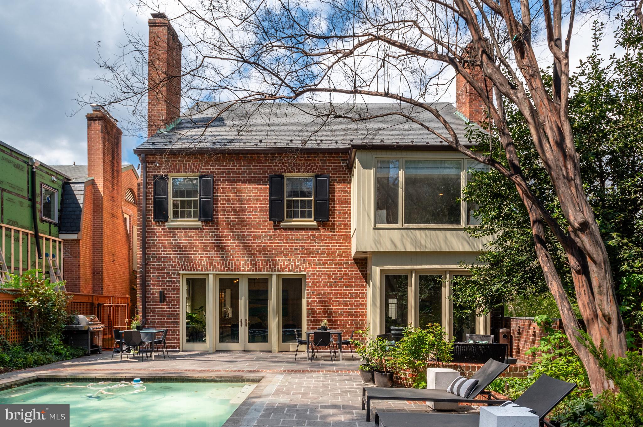 2468 Belmont Road Northwest Washington, DC 20008 - Photo 44 of 49 a front view of a house with swimming pool and glass windows