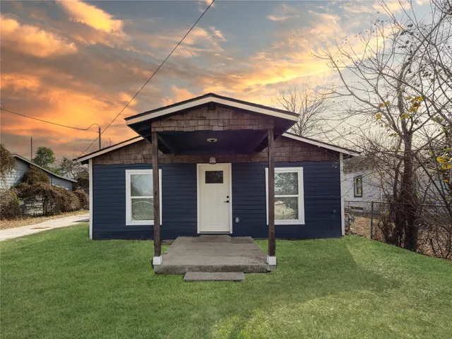 a front view of a house with a garden