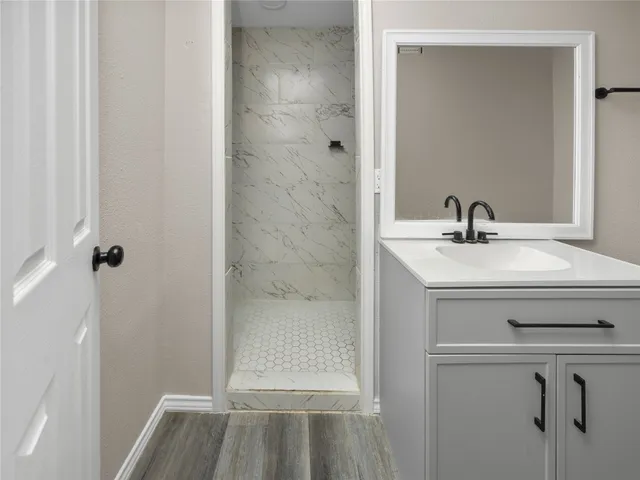 a bathroom with a sink a vanity and a mirror