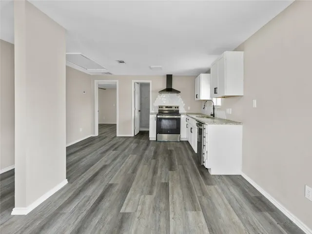 a view of kitchen with sink stainless steel appliances and cabinets