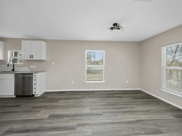 a view of kitchen and window with wooden floor