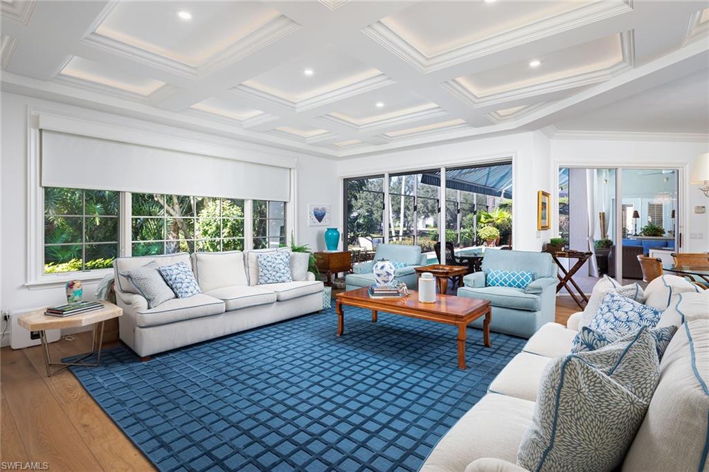 6975 Green Tree Drive Naples, FL 34108 - Photo 11 of 33 Sunroom featuring hardwood / wood-style floors, coffered ceiling, healthy amount of natural light, beam ceiling, and crown molding
