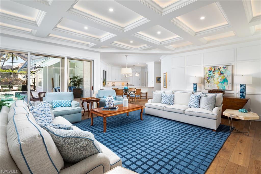 6975 Green Tree Drive Naples, FL 34108 - Photo 12 of 33 Living room featuring coffered ceiling, hardwood / wood-style flooring, beamed ceiling, and ornamental molding