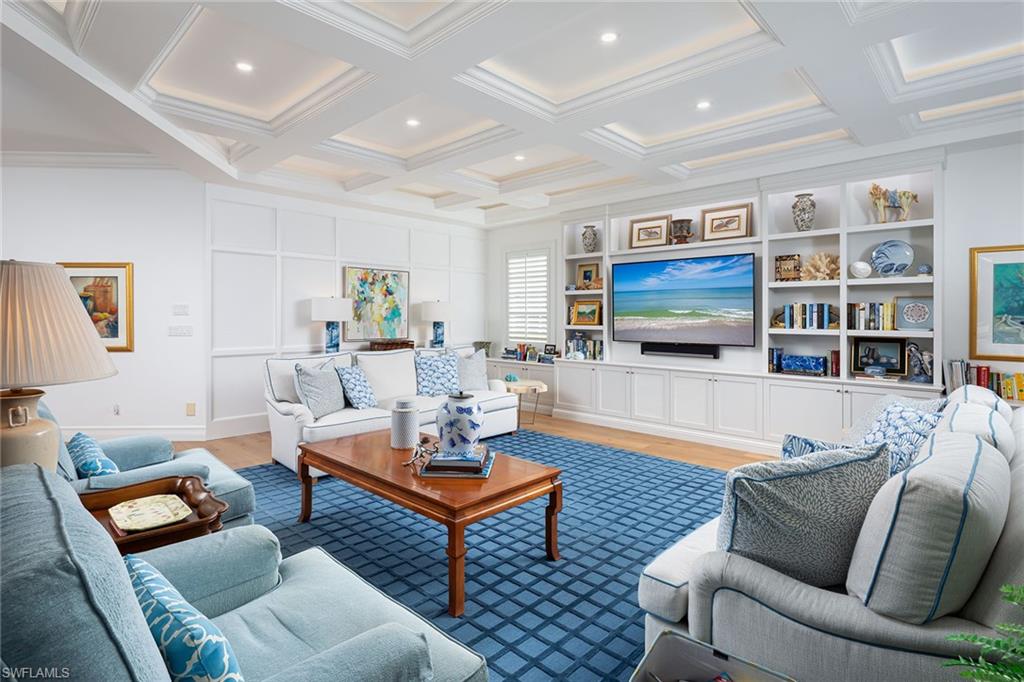 6975 Green Tree Drive Naples, FL 34108 - Photo 13 of 33 Living room with light wood-style flooring, coffered ceiling, beamed ceiling, and ornamental molding