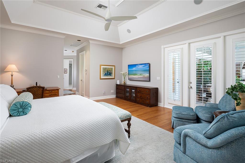 6975 Green Tree Drive Naples, FL 34108 - Photo 15 of 33 Bedroom with access to exterior, light wood-type flooring, a ceiling fan, and ornamental molding