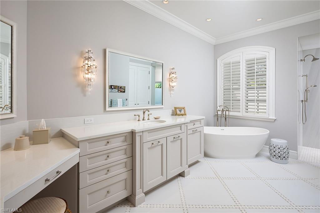 6975 Green Tree Drive Naples, FL 34108 - Photo 16 of 33 Bathroom featuring vanity, a freestanding bath, ornamental molding, a shower, and recessed lighting