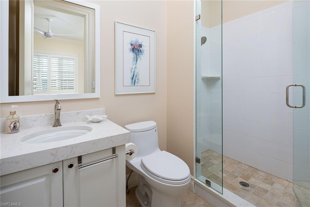 6975 Green Tree Drive Naples, FL 34108 - Photo 23 of 33 Bathroom with vanity, a stall shower, and ceiling fan
