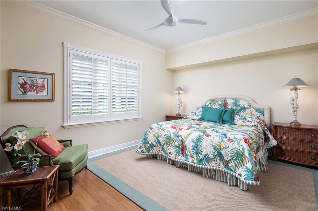 6975 Green Tree Drive Naples, FL 34108 - Photo 24 of 33 Bedroom with ornamental molding, a ceiling fan, and wood finished floors