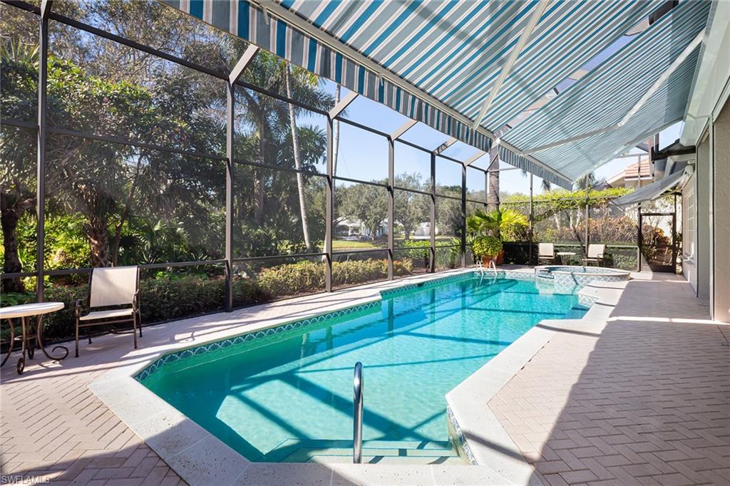 6975 Green Tree Drive Naples, FL 34108 - Photo 28 of 33 View of swimming pool with a patio area, a lanai, a pool with connected hot tub, and a sunroom