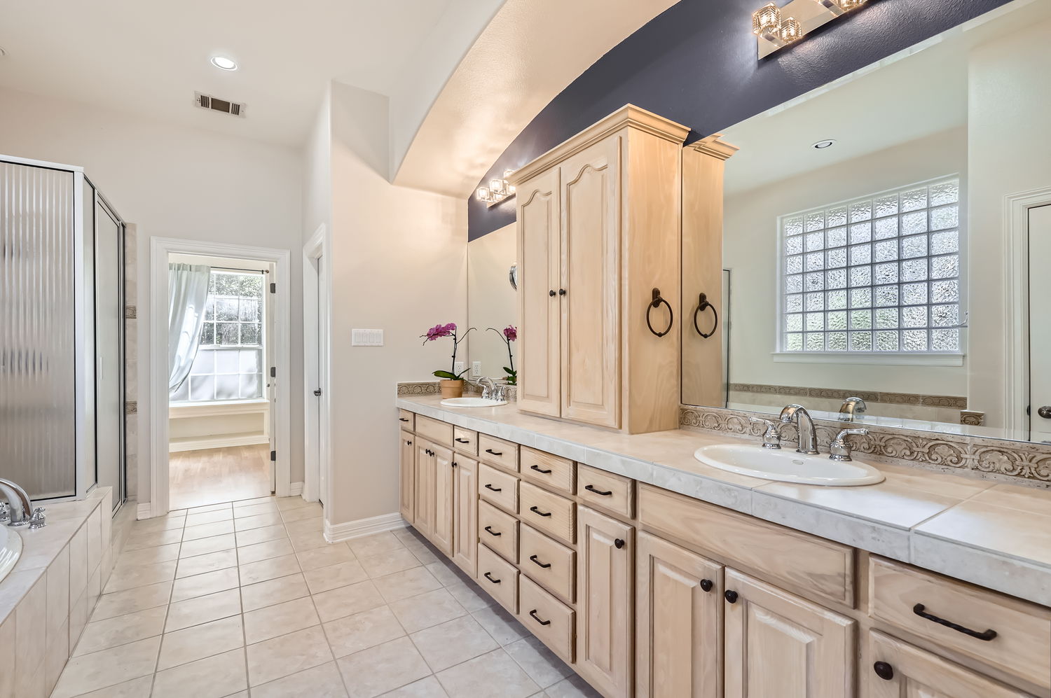 210 Amandas Way Leander, TX 78641 - Photo 19 of 38 Full bathroom featuring double vanity, tile patterned flooring, visible vents, and a sink