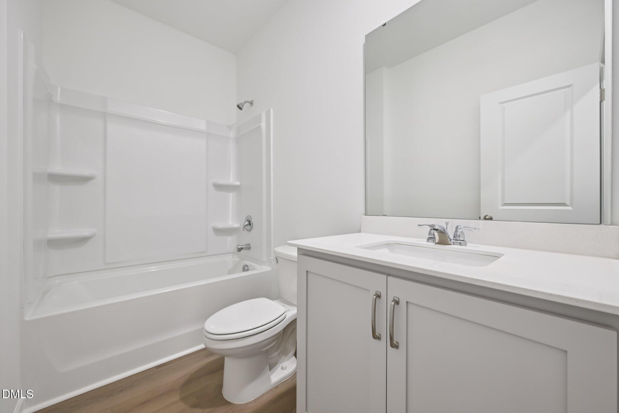 11730 Salers Loop Middlesex, NC 27557 - Photo 16 of 47 a bathroom with a sink a toilet and a bathtub