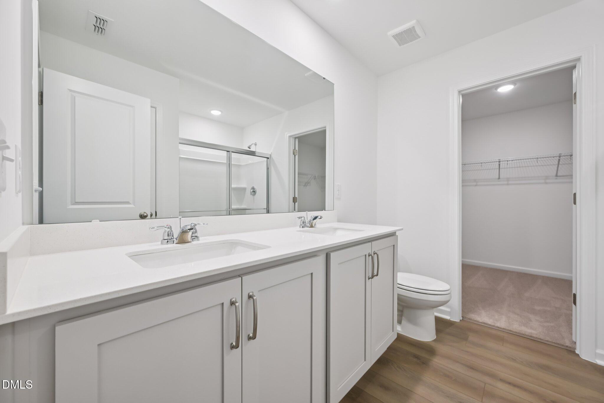 11730 Salers Loop Middlesex, NC 27557 - Photo 25 of 47 a bathroom with a sink a toilet and a large mirror