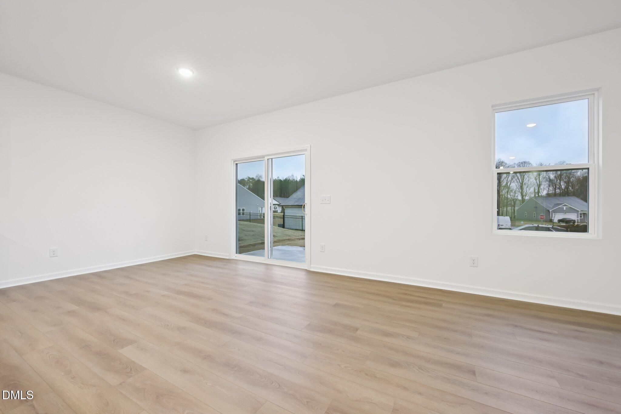 11730 Salers Loop Middlesex, NC 27557 - Photo 8 of 47 a view of an empty room with wooden floor and a window