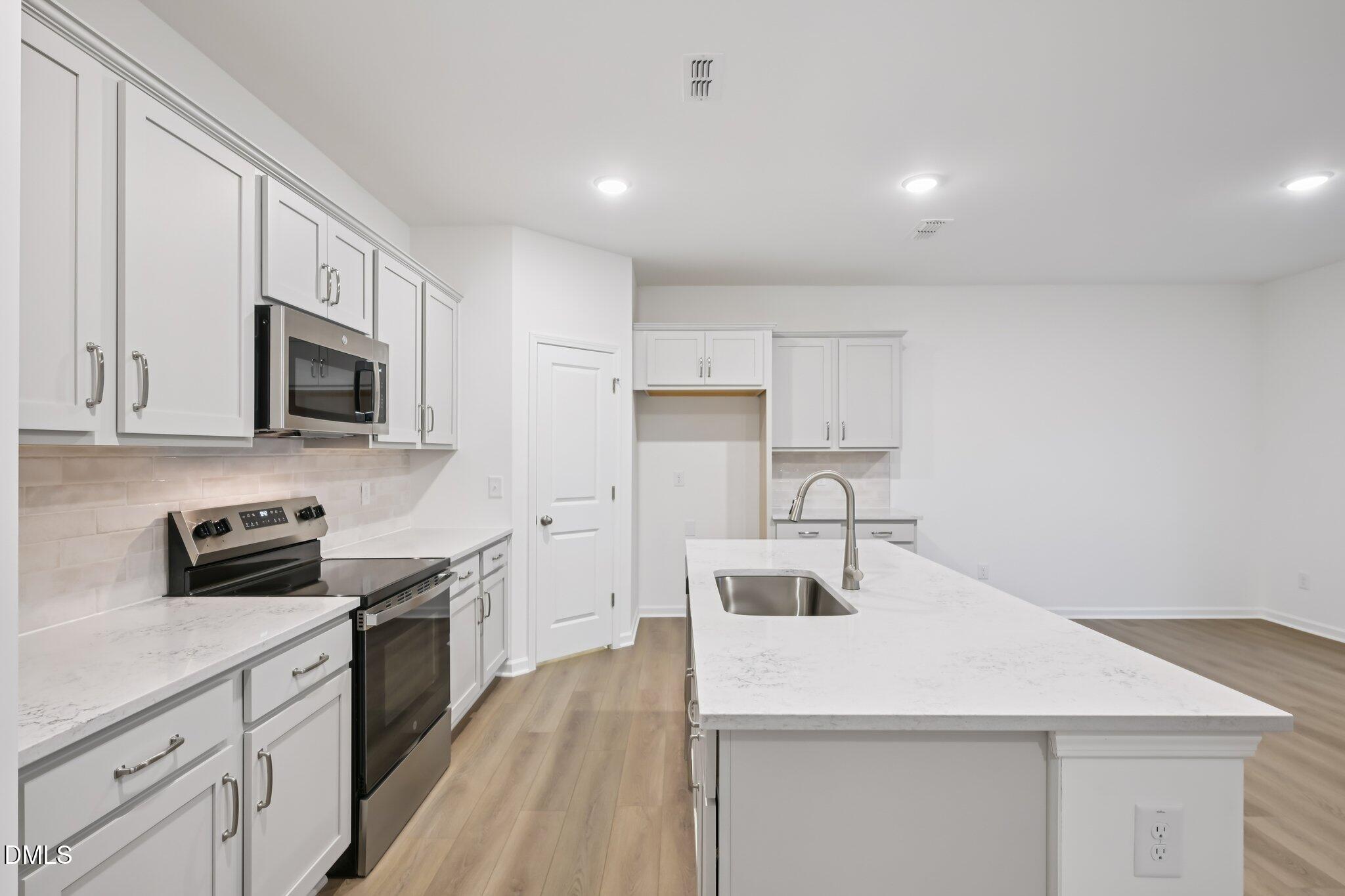 11730 Salers Loop Middlesex, NC 27557 - Photo 10 of 47 a kitchen with stainless steel appliances granite countertop a sink stove microwave and refrigerator