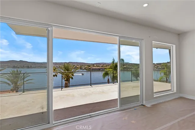 a view of an empty room with a sliding door and a window