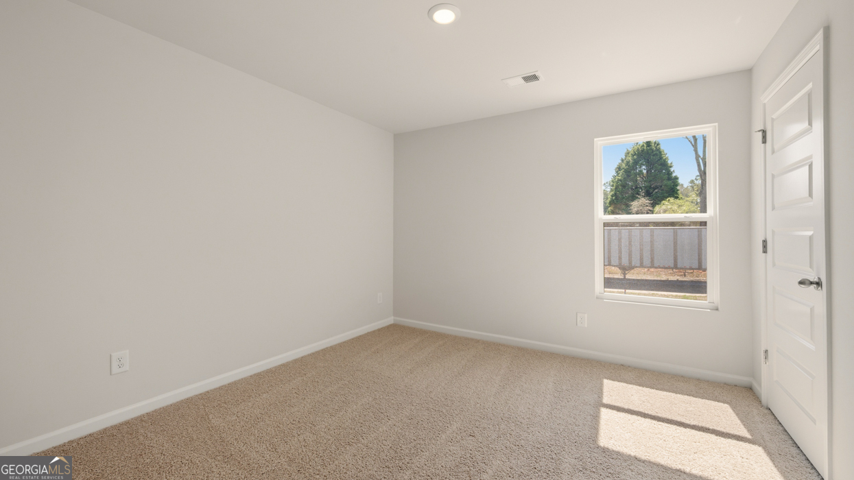 8578 Seabiscuit Road Lithonia, GA 30058 - Photo 20 of 30 an empty room with a window