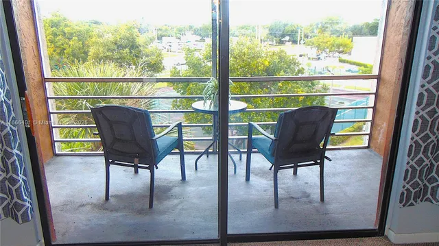 a view of a chairs and table in patio