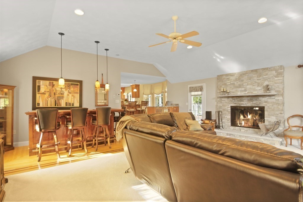 5 Judith E Lane Methuen, MA 01844 - Photo 11 of 38 a living room with furniture a dining table and a fireplace