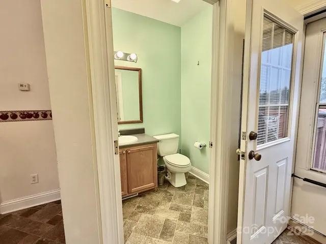a bathroom with a toilet sink and a mirror