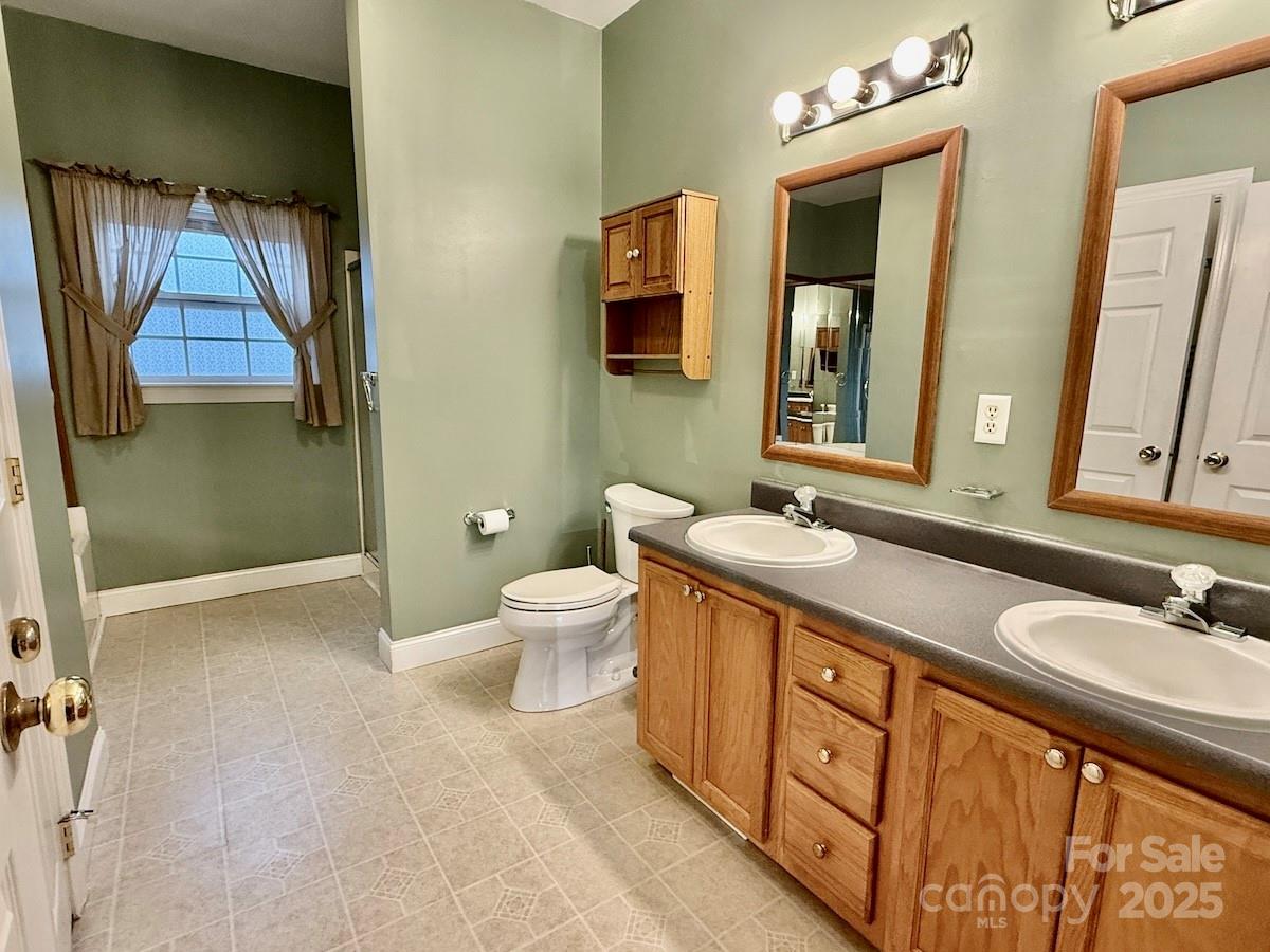 1054 Sandy Springs Road Rutherfordton, NC 28139 - Photo 14 of 33 a spacious bathroom with 2 sink toilet and a mirror