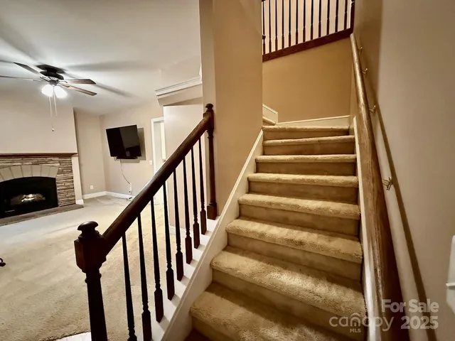 a view of an empty room with window and stairs