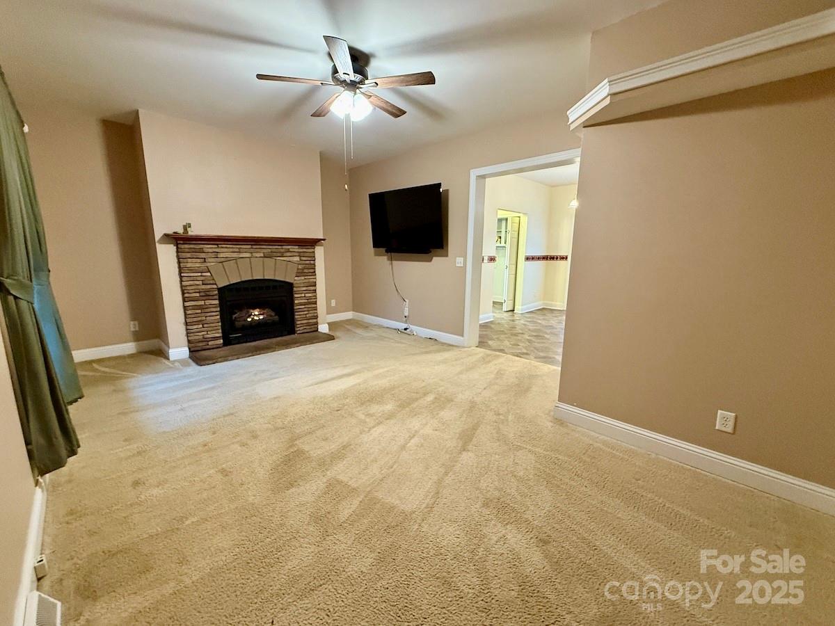1054 Sandy Springs Road Rutherfordton, NC 28139 - Photo 3 of 33 a view of a livingroom with a fireplace a ceiling fan and entryway