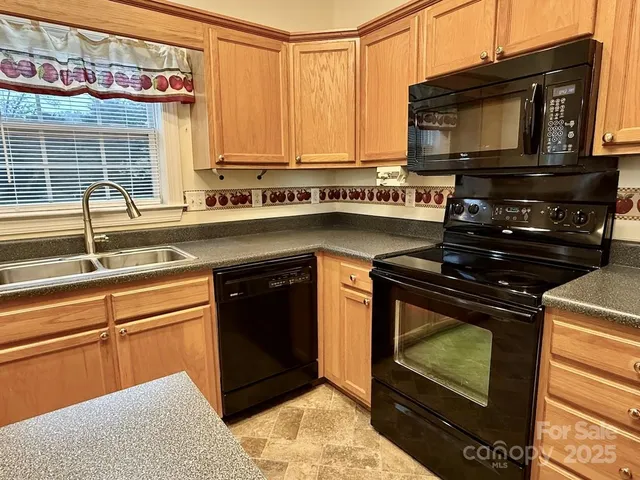 a kitchen with stainless steel appliances granite countertop a stove and a microwave