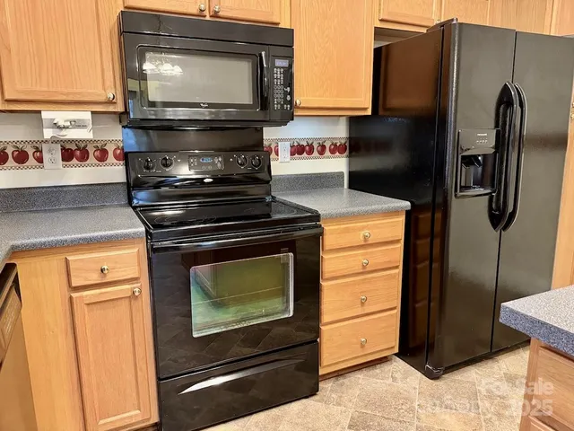 a kitchen with appliances and cabinets
