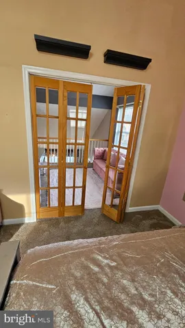 walk in closet with wooden floor and windows