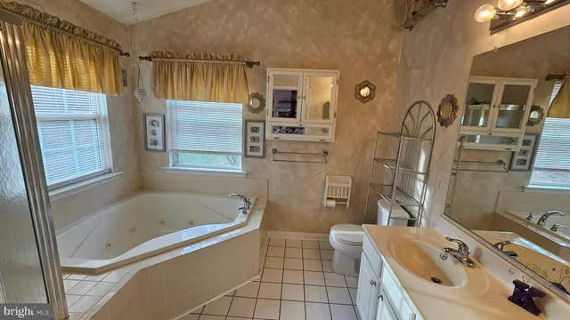 a view of water heater room with window and refrigerator