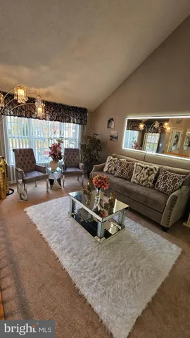 a living room with furniture gym equipment and a window