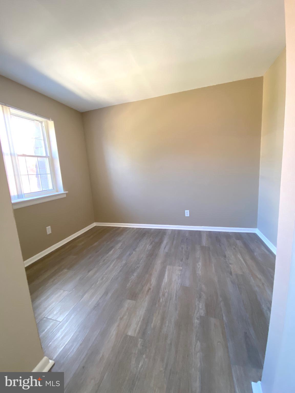 4000 Gypsy Lane, Unit 520 Philadelphia, PA 19129 - Photo 11 of 18 an empty room with wooden floor and windows