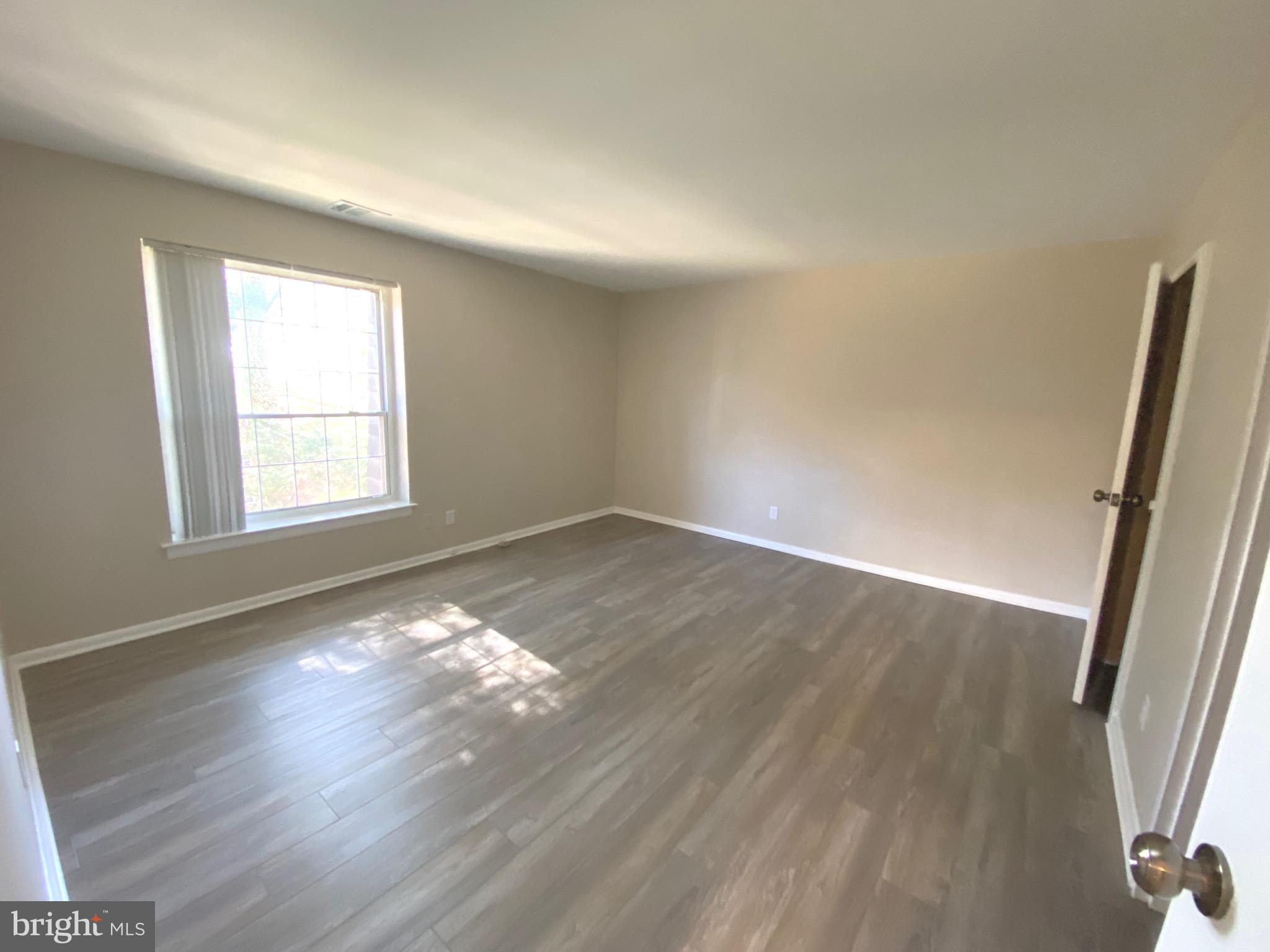 4000 Gypsy Lane, Unit 520 Philadelphia, PA 19129 - Photo 12 of 18 wooden floor in an empty room with a window