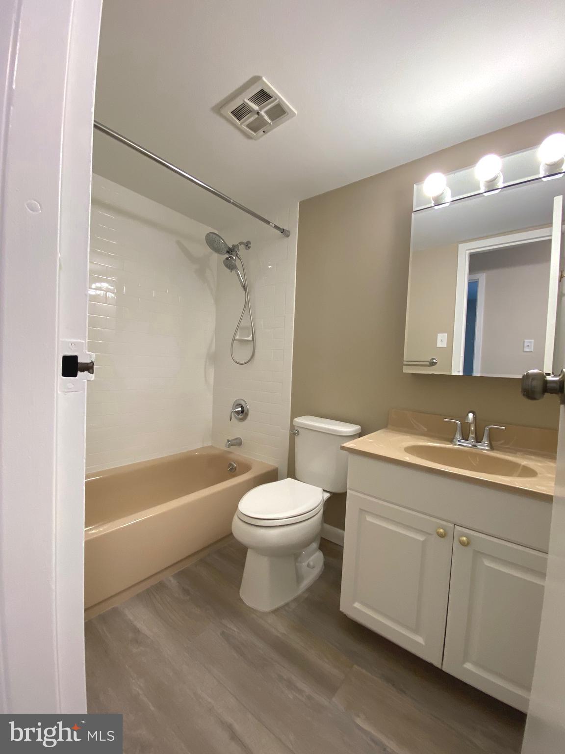 4000 Gypsy Lane, Unit 520 Philadelphia, PA 19129 - Photo 16 of 18 a bathroom with a sink a toilet and a mirror