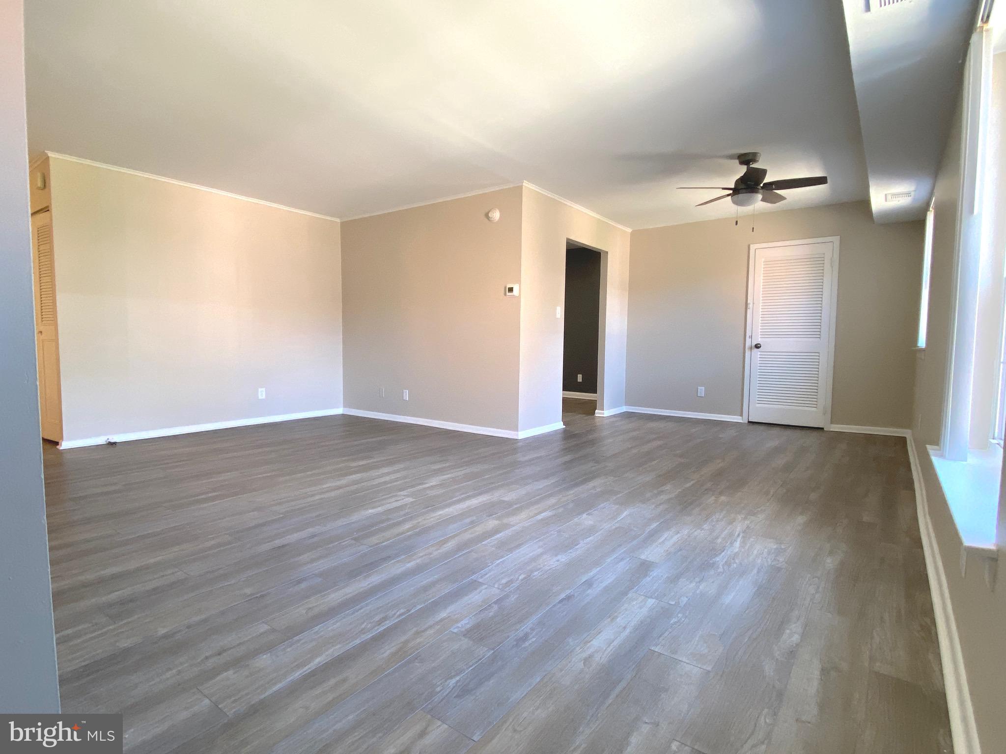 4000 Gypsy Lane, Unit 520 Philadelphia, PA 19129 - Photo 8 of 18 an empty room with wooden floor and windows