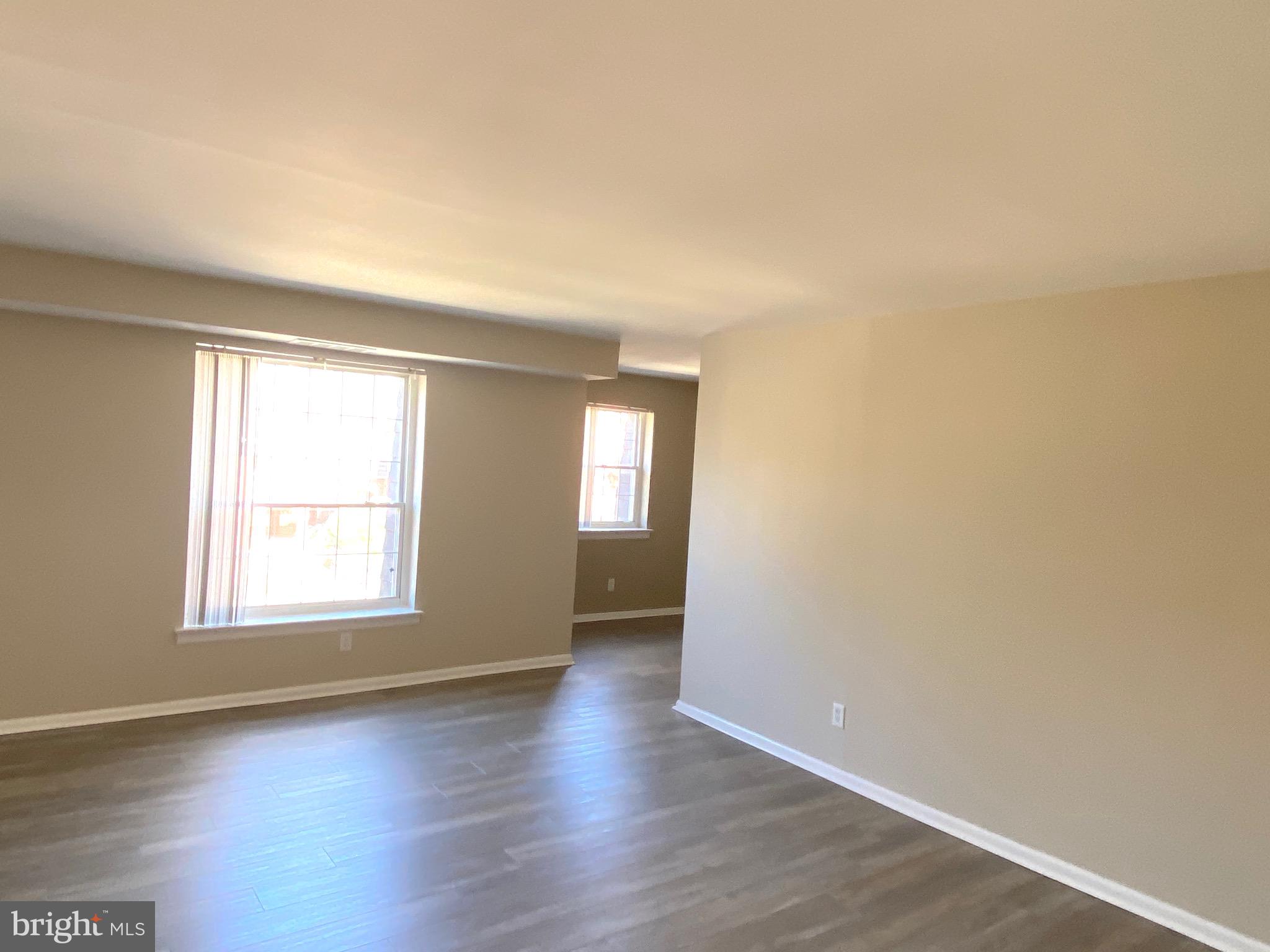 4000 Gypsy Lane, Unit 520 Philadelphia, PA 19129 - Photo 10 of 18 an empty room with wooden floor and windows