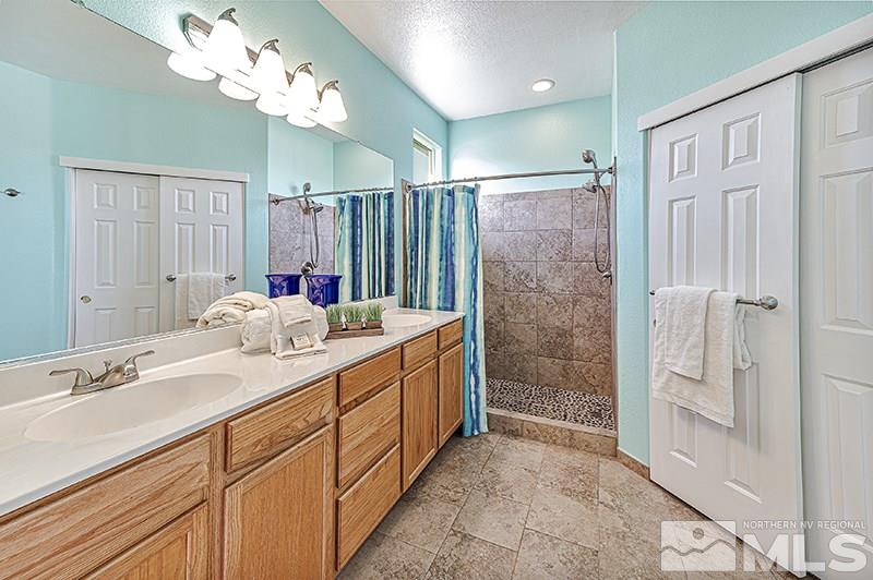 10442 Rockport Lane Reno, NV 89521 - Photo 12 of 17 a bathroom with a double vanity sink mirror and shower