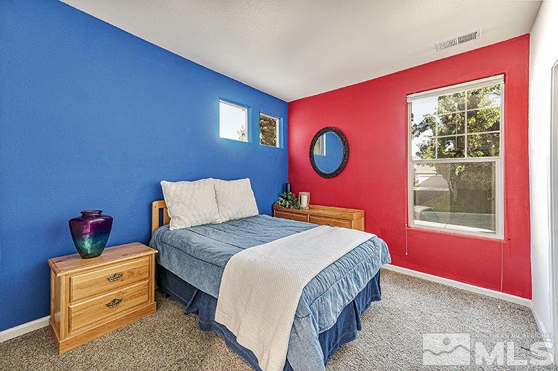 10442 Rockport Lane Reno, NV 89521 - Photo 16 of 17 a bedroom with a bed and a dresser next to a window