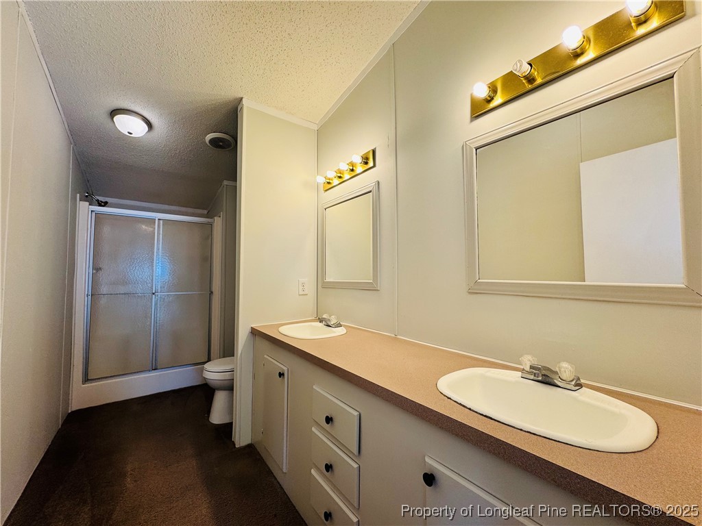 2475 Dunn Road Eastover, NC 28312 - Photo 12 of 17 a bathroom with a double vanity sink and mirror