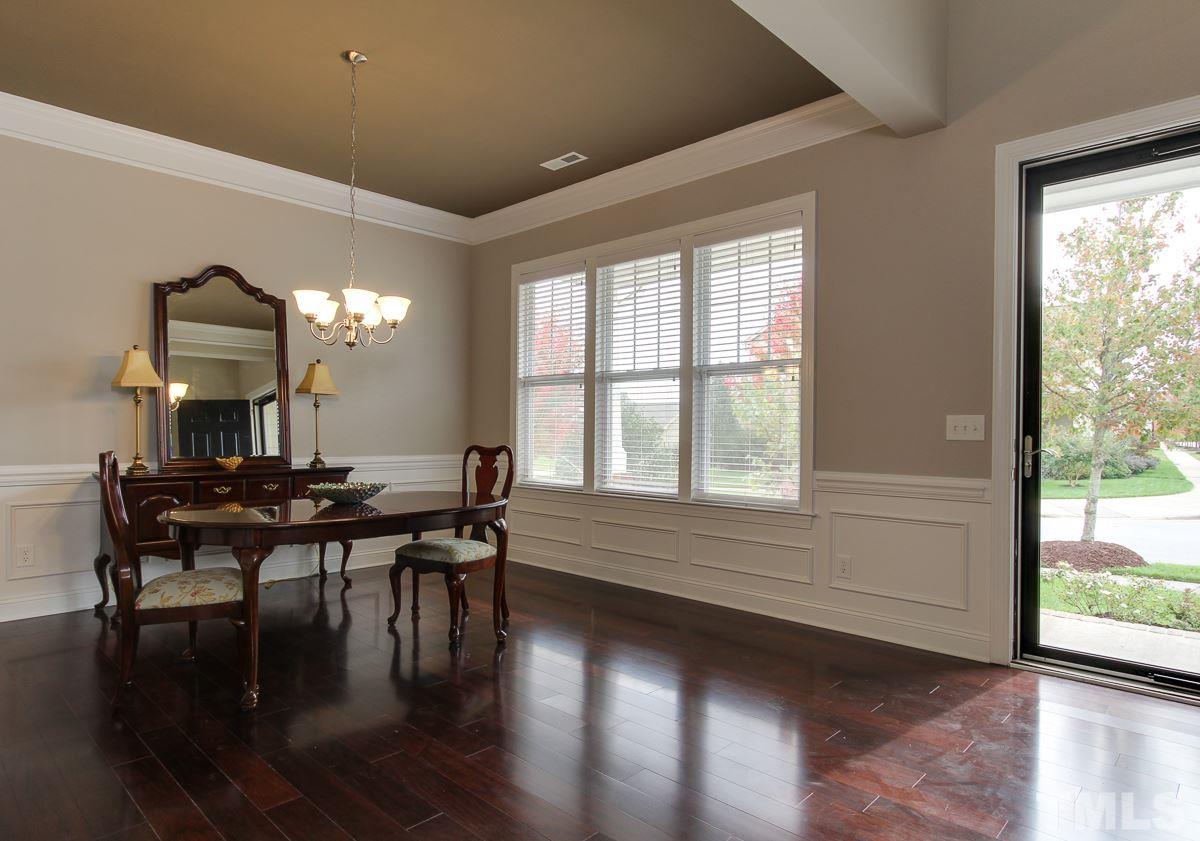932 Chapanoke Road Raleigh, NC 27603 - Photo 2 of 25 a view of a dining room with furniture a chandelier and wooden floor