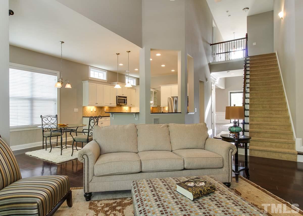 932 Chapanoke Road Raleigh, NC 27603 - Photo 11 of 25 a living room with furniture and a chandelier