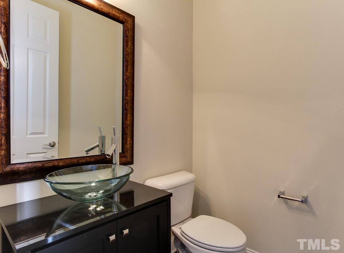 932 Chapanoke Road Raleigh, NC 27603 - Photo 12 of 25 a bathroom with a toilet sink and mirror