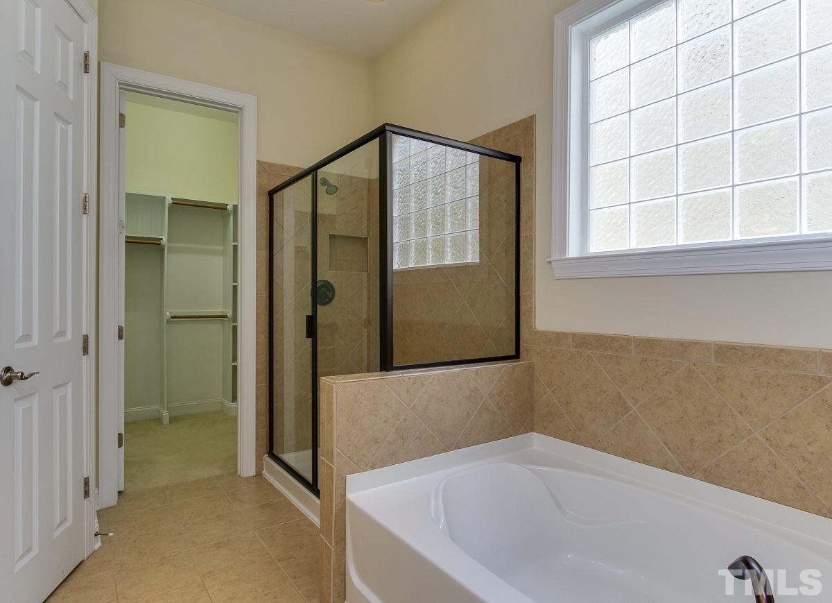 932 Chapanoke Road Raleigh, NC 27603 - Photo 16 of 25 a bathroom with a bathtub and a shower